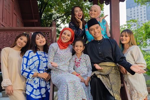 A group of malay people at the wooden house celebrating Hari Raya festive
