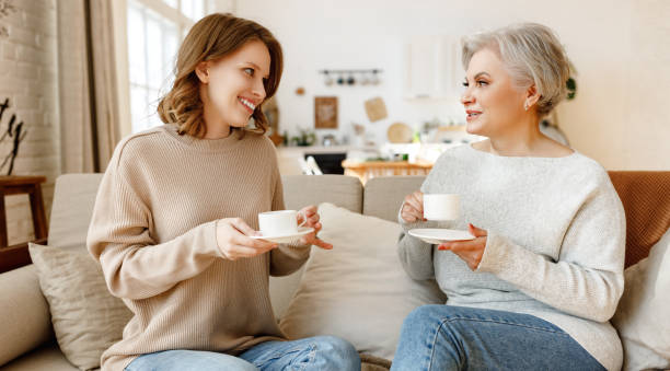 istock Happy mother and daughter drinking tea at home 1308645679