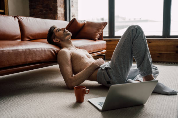 istock Man with scars at the skin after burn relaxing while using laptop and drinking tea 1308645940