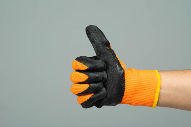 A hand in a working glove with a raised thumb shows ok or good.