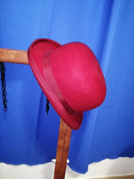 istock red bowler hat hanging or standing 1308650246