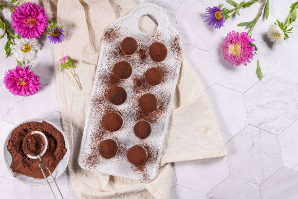 istock Fine chocolate truffles on white ceramic plate. 1308652806