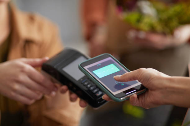 istock Unrecognizable Woman Paying by Smartphone 1308652944