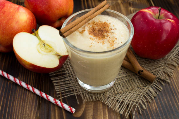 istock Smoothie from red apple and cinnamon on the rustic wooden background 1308653283