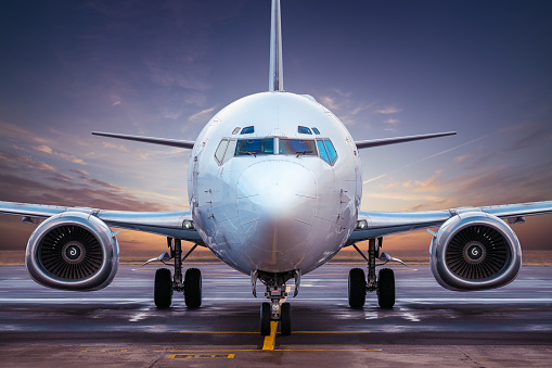 modern airliner at an airfield while sunset