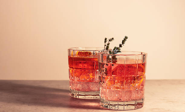 coquetel de gim rosa com laranja de sangue vermelho e gelo. uma bebida alcoólica e refrescante. - gin - fotografias e filmes do acervo