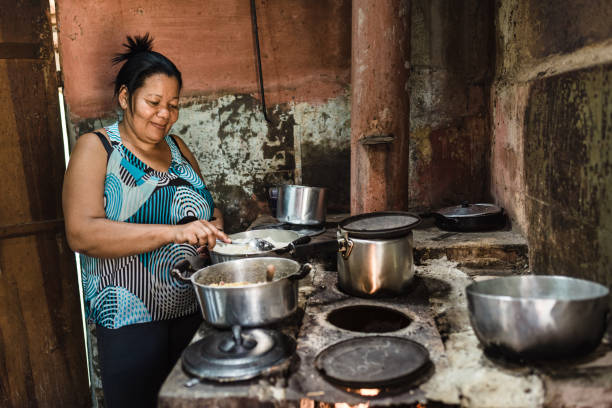 Woman cooking on wood stove