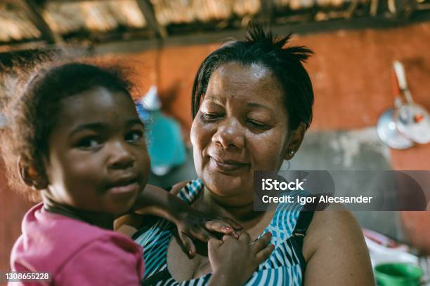 Grandmother With Granddaughter On Her Lap Stock Photo - Download Image Now - Poverty, Child, House