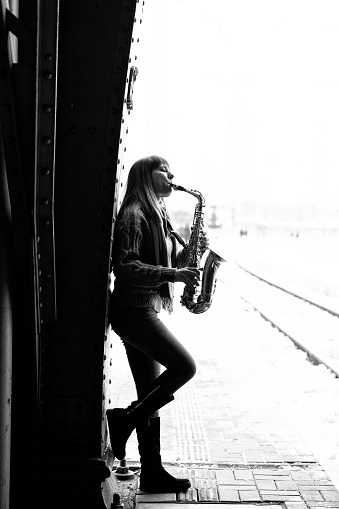 Beautiful woman playing saxophone