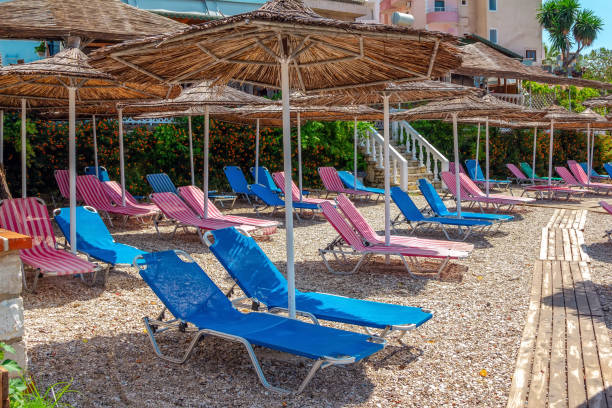 istock View of empty beach - colorful sun beds and umbrellas 1308656636