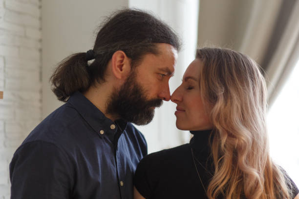 istock Man embracing pregnant partner in kitchen. 1308657217
