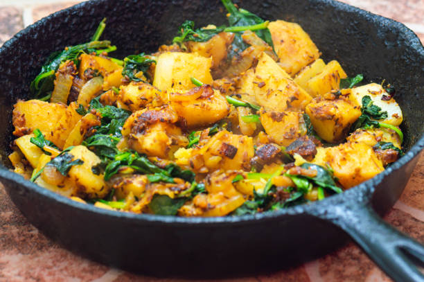Saag Aloo, Indian style spinach and potato dish in cast iron pan