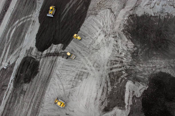 istock Bulldozer and trucks on a disposal site - aerial view 1308657666