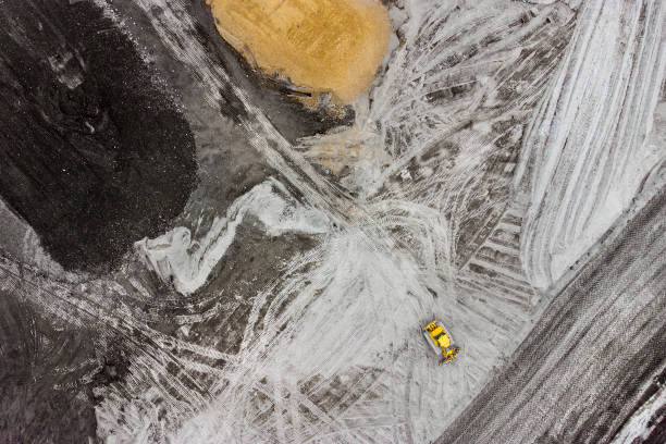 istock Bulldozer and trucks on a disposal site - aerial view 1308657693