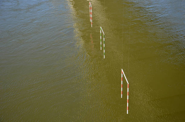 racing slalom goals for canoe and raft, kayak. Racing track with suspended striped bars on a wild and calm river. both beginner and advanced paddler ride
