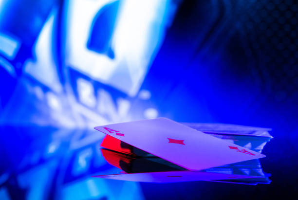 Poker Playing Cards on a Glassy Table with Blue Illumination. Casino Gambling Theme.