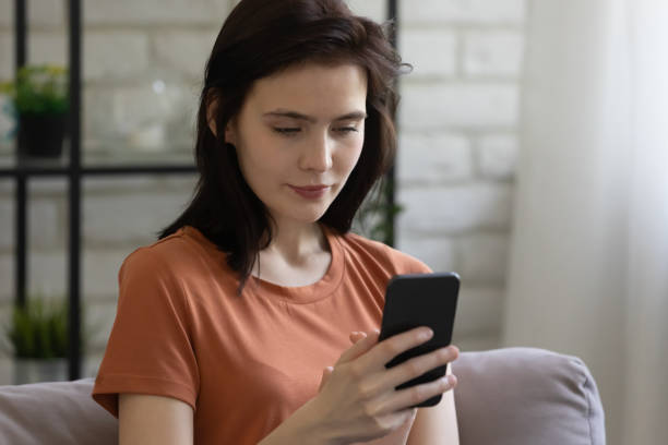 istock Close up attractive young woman using smartphone, chatting online 1308658882
