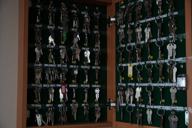 Close up view on open cabinet with different keys to enter all rooms, cabinets and lockers on the freight container vessel. Close up view on wooden open cabinet with different keys to enter all rooms, cabinets and lockers on the freight container vessel. key package stock pictures, royalty-free photos & images
