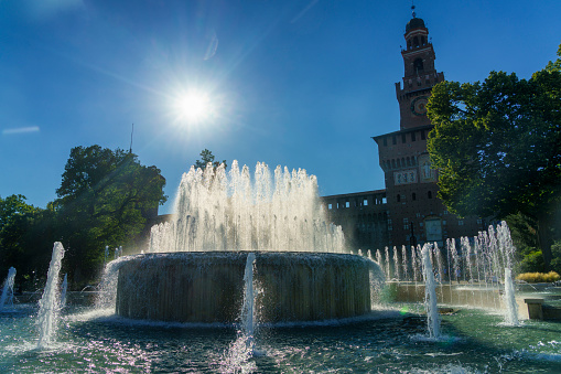 Milan, Italy - July 16, 2020: Milan, Lombardy, Italy: historic fountain in the square of the castle known as Castello Sforzesco