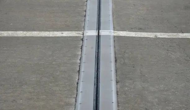 Photo of roof structure or bridge expansion for safe connection of two expandable concrete bodies. rubber joint in a metal bar