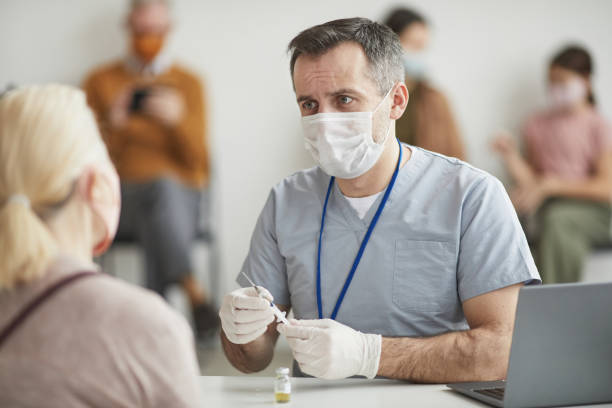 istock Doctor Consulting Patient at Vaccination 1308661609