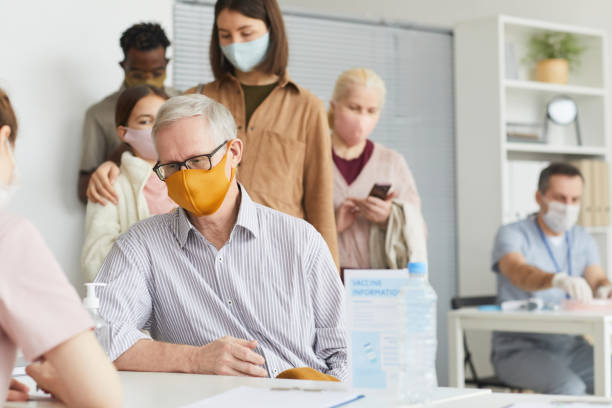 istock Senior Man Registering at Vaccination Center 1308661685