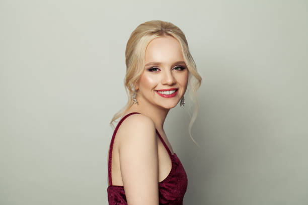 istock Happy young blonde woman smiling on white background 1308661799