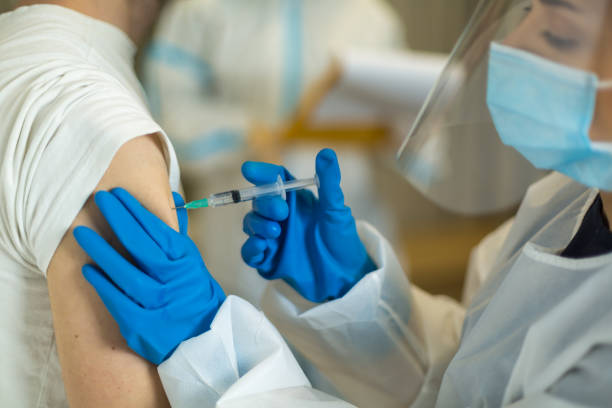 istock Injecting flu vaccine into patient's arm 1308663911