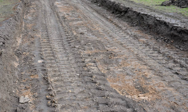 istock preparing a new path by removing a layer of soil. the space will be filled with stones and gravel. asphalt is rolled on top. the soil is deposited in a landfill 1308664078