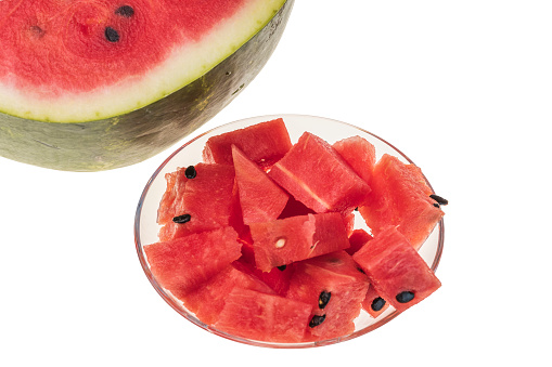 Close up view of  whole and diced watermelon on white background.