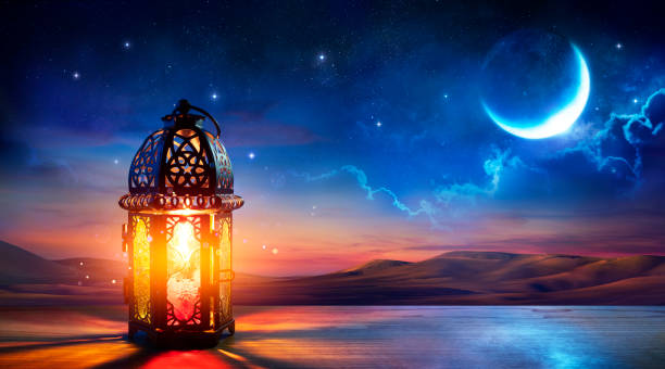 muslim holy month ramadan kareem - ornamental arabic lantern with burning candle glowing at evening - nocturnal image imagens e fotografias de stock