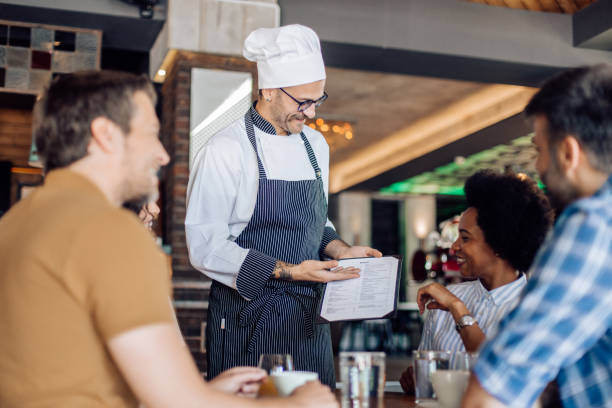 istock Group of colleagues ordering lunch in a restaurant 1308670415