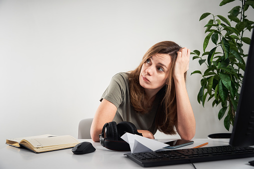 Woman procrastinate at home workplace. Online work and home office problem
