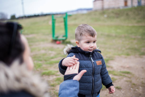 istock Mum playing with her young boy outdoors 1308672019