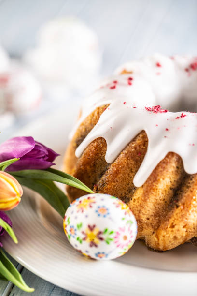 istock Festive easter marble cake with icing sugar hand-decorated eggs and spring tulips 1308672085
