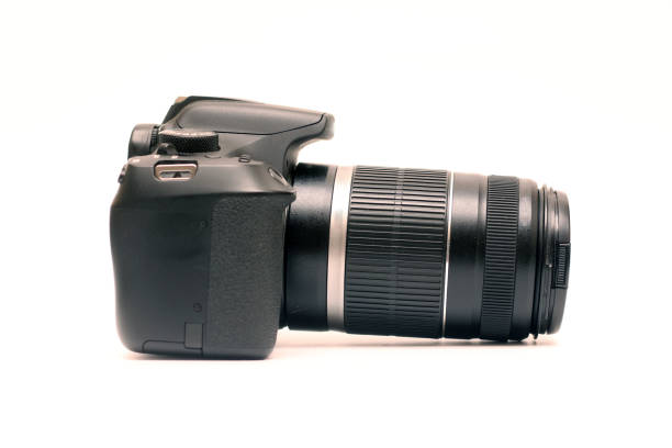 istock No logos digital SLR camera with 55-250 zoom lens with image stabilization. Right side view, studio shooting on a white background 1308675696