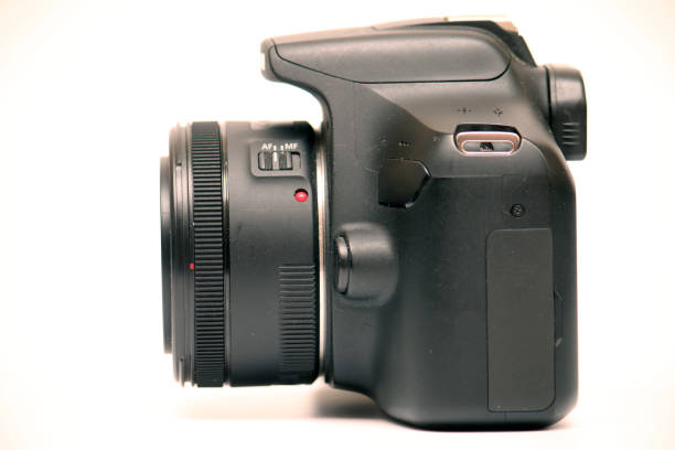 istock No label digital SLR camera camera with 50mm 1.8 prime lens. Side view studio shot on white background 1308675698