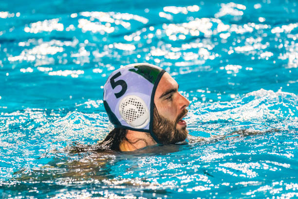 Water polo player swimming Water polo player in the pool water polo cap stock pictures, royalty-free photos & images