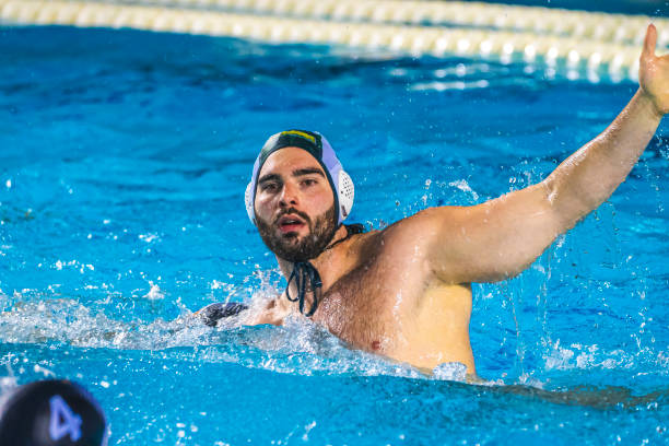 Water polo player swimming Water polo player in the pool water polo cap stock pictures, royalty-free photos & images