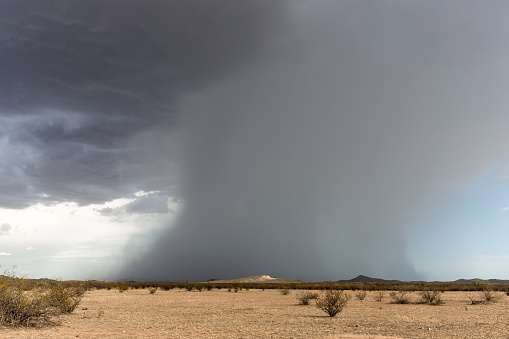 Microburst with heavy rain and dark storm clouds from a thunderstorm near Wickenburg, Arizona.