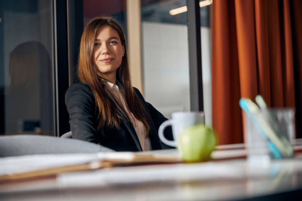 istock Calm pleased office worker sitting at the table 1308677518