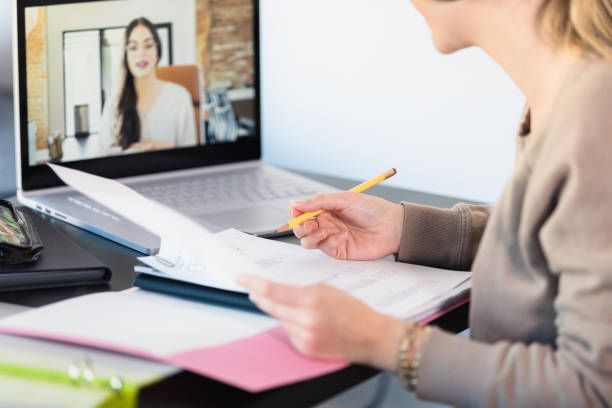 istock Unrecognizable female student listens to online tutor 1308679947