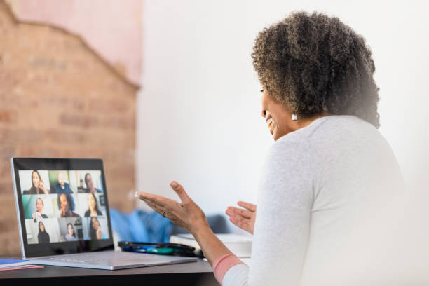istock Woman gestures and smiles during virtual meeting 1308679962