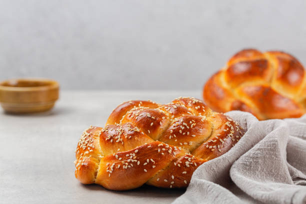 istock Delicious rose braid bread with sesame seeds. Homemade. Light grey background, copy space. 1308680208