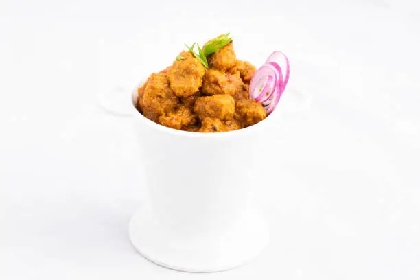 Photo of Veg Curry Masala Sabji Soya Chunks Nutri Nugget Made Of Soy Served In White Balti. The Sabzi Is Rich Source Of Protein And Has Multiple Health Benefits. White Background With Space For Text