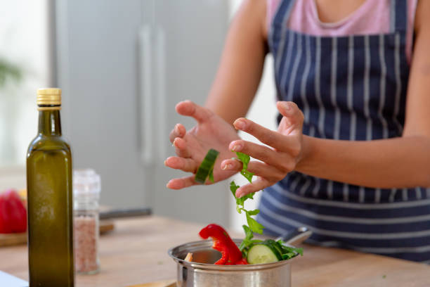 istock Caucasian woman standing in kitchen making dinner 1308682645