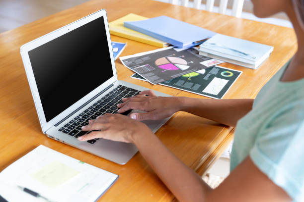 istock Caucasian woman sitting by desk working from home using laptop 1308684978