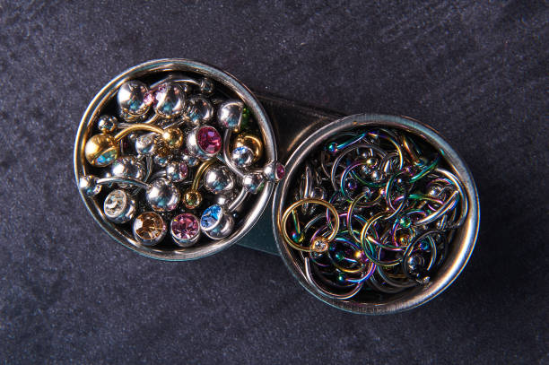 istock Piercings earrings close-up. On a black background 1308686309