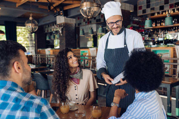 istock Group of colleagues ordering food at the restaurant after work 1308691530