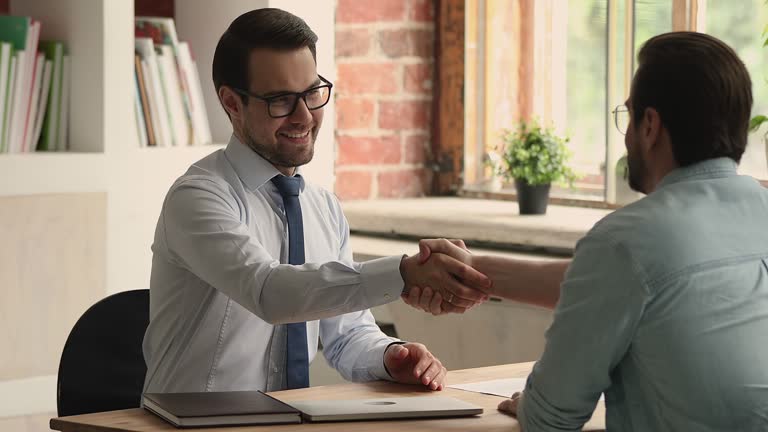 HR manager shake hands hired applicant accomplishing successfully job interview